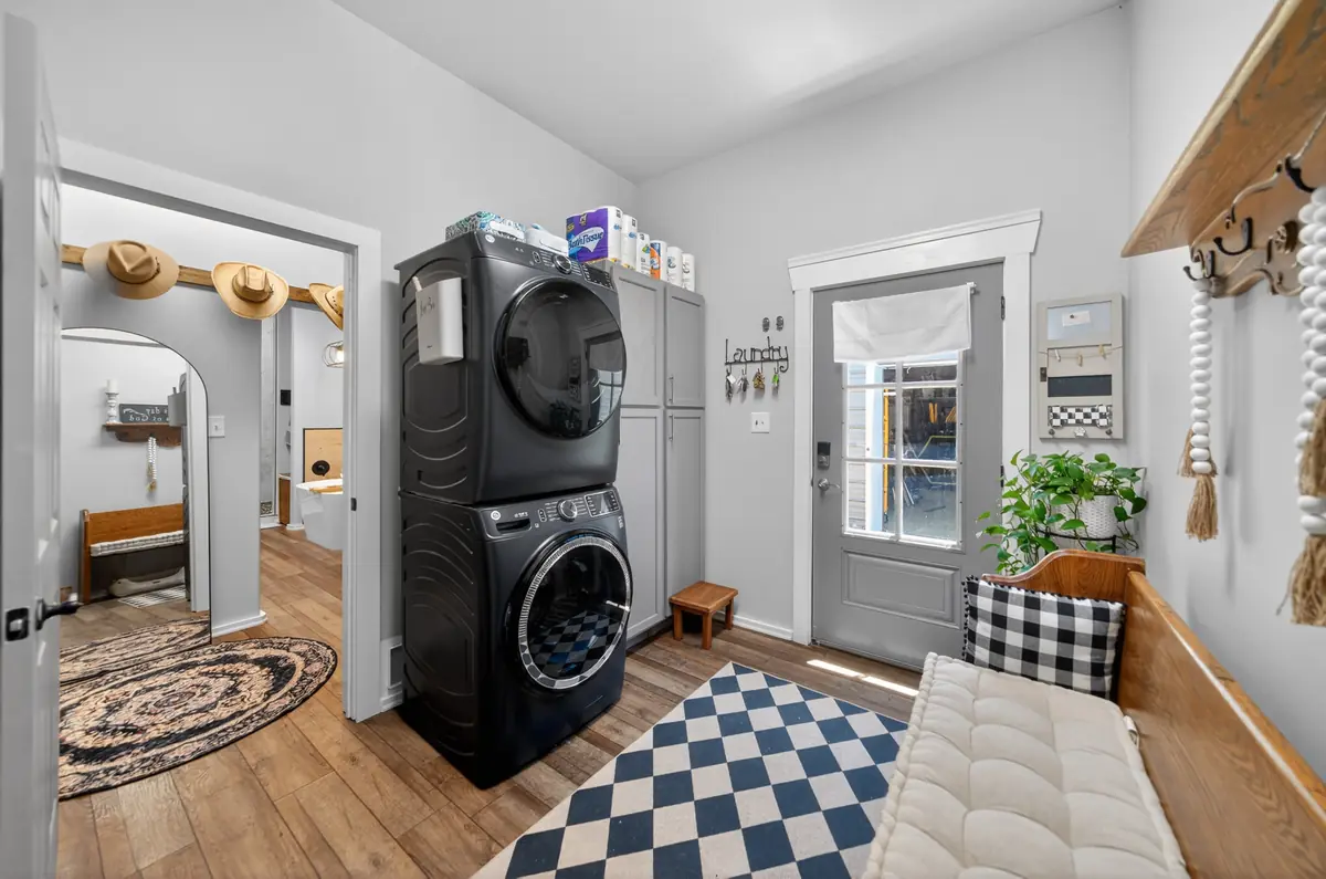 Dedicated laundry room with stacked washer and dryer, barndominium Chandler TX