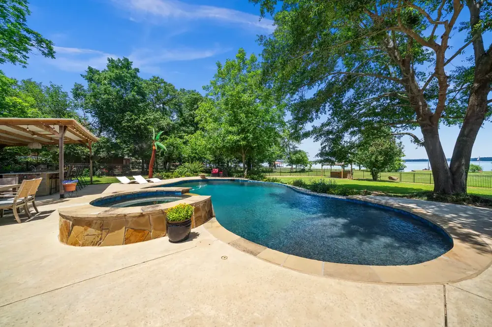 Sunrise Shores Lake Palestine waterfront home exterior brick with large yard at 4911 Sunrise Dr Chandler TX for sale