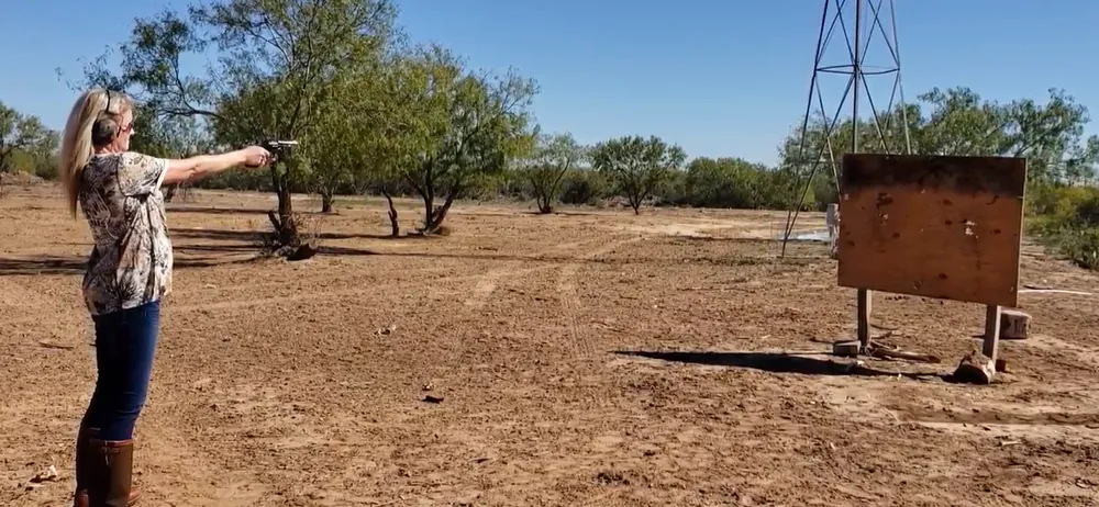 Charlene Hall shooting a pistol at a target on the ranch in Encinal Texas