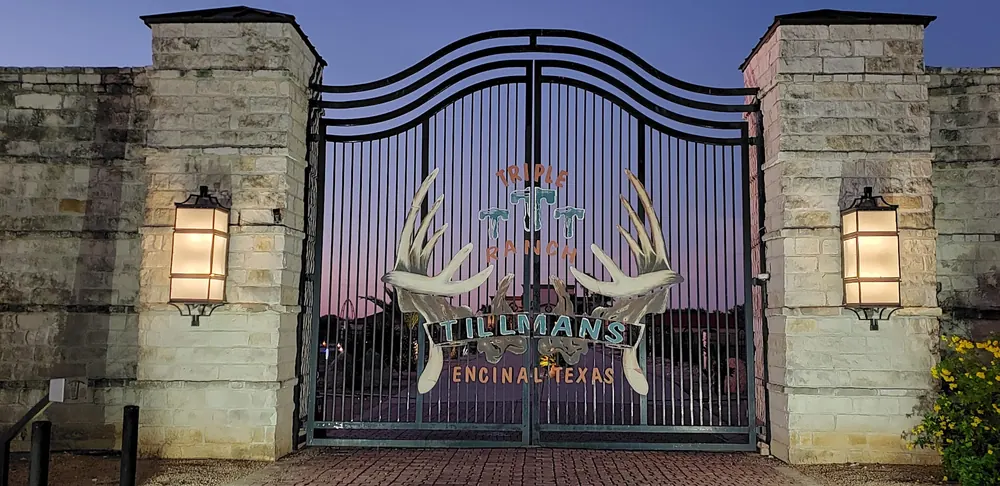 Triple T Tillmans Ranch gate at dusk in Encinal, Texas