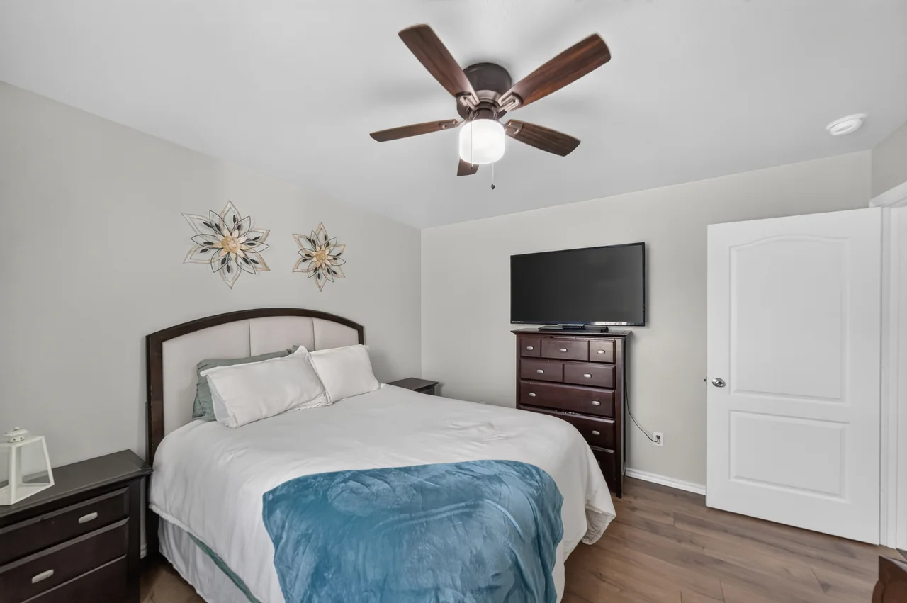 Second bedroom with ceiling fan at 1054 Caroline Ln in Shadybrook, a gated Lake Palestine community in Bullard, TX.