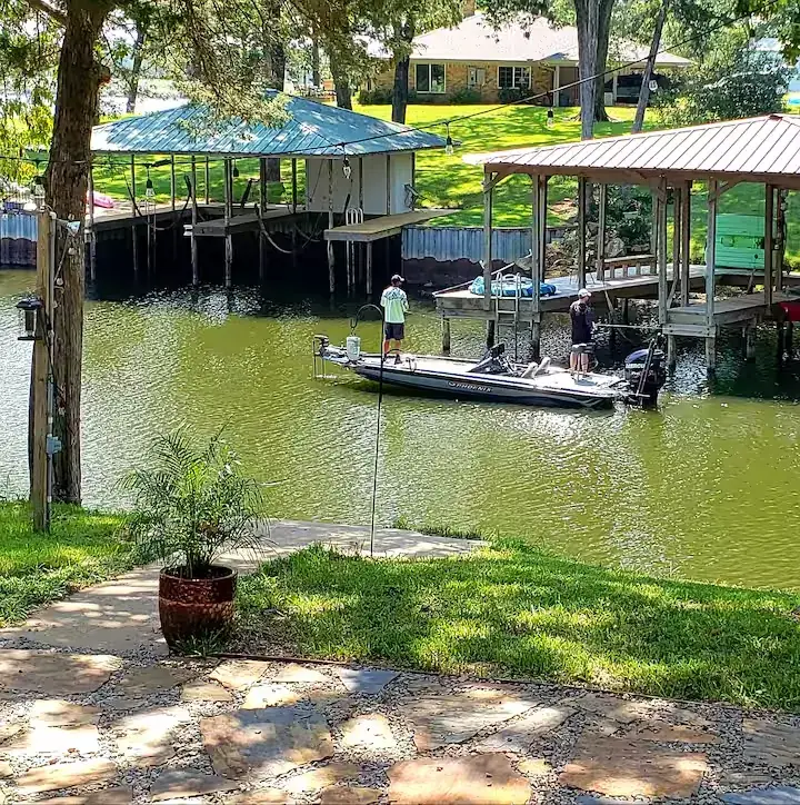 Calm, sheltered cove on Lake Palestine with private boathouses and a bass boat