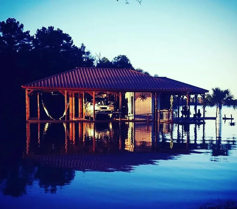 High water on Lake Palestine after heavy rain, with a boathouse surrounded by the risen lake.